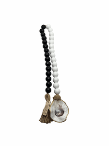 boho white and black beads coastline with gilded oyster shell. product shot