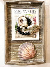 Load image into Gallery viewer, boho white and black beads coastline with gilded oyster shell. lifestyle wrapped on magazine shot